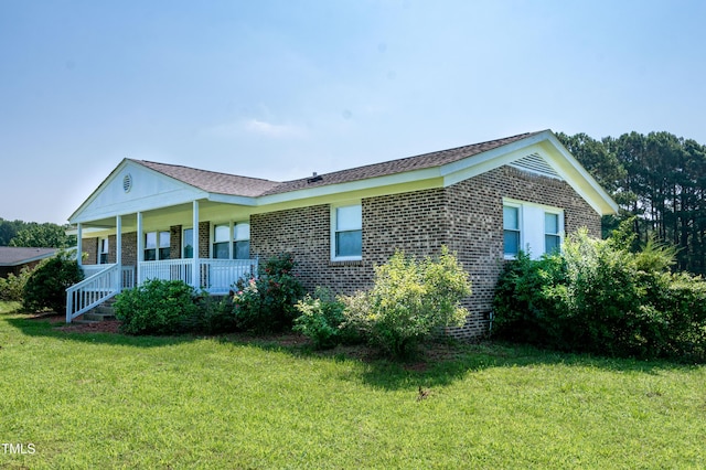 5840 Rocking Chair Dr, Youngsville, NC 27596 - view of side of property featuring covered porch, a lawn, and brick siding
