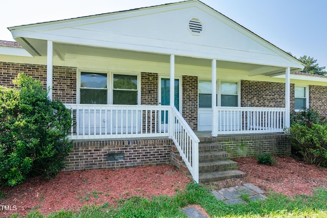5840 Rocking Chair Dr, Youngsville, NC 27596 - view of front of house featuring covered porch and brick siding
