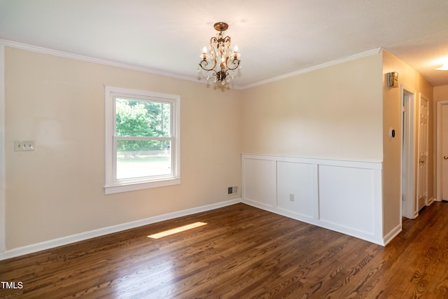 5840 Rocking Chair Dr, Youngsville, NC 27596 - spare room featuring a chandelier, dark wood-style floors, ornamental molding, and a wainscoted wall