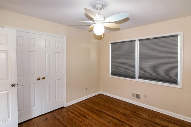 5840 Rocking Chair Dr, Youngsville, NC 27596 - unfurnished bedroom with a closet, dark wood-style flooring, and ceiling fan