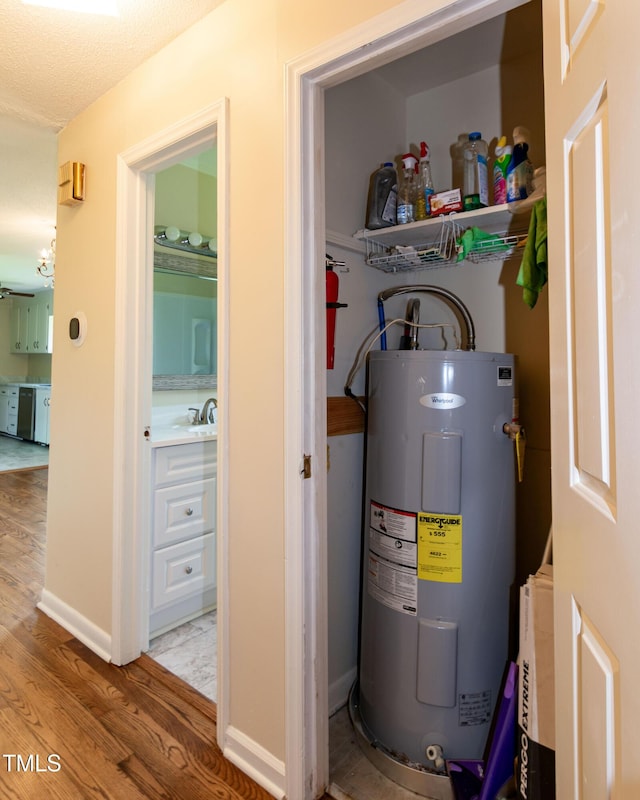 5840 Rocking Chair Dr, Youngsville, NC 27596 - utility room with electric water heater and a sink
