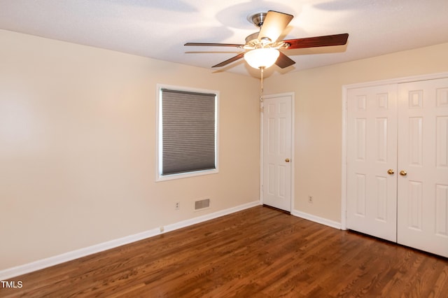 5840 Rocking Chair Dr, Youngsville, NC 27596 - unfurnished bedroom with wood finished floors, ceiling fan, and a closet