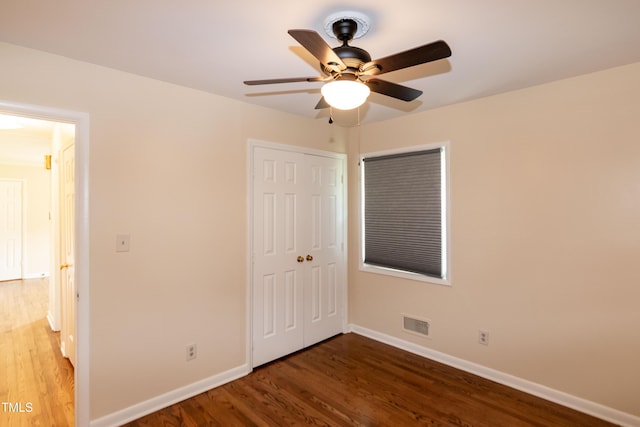 5840 Rocking Chair Dr, Youngsville, NC 27596 - unfurnished bedroom with wood finished floors, a closet, and ceiling fan