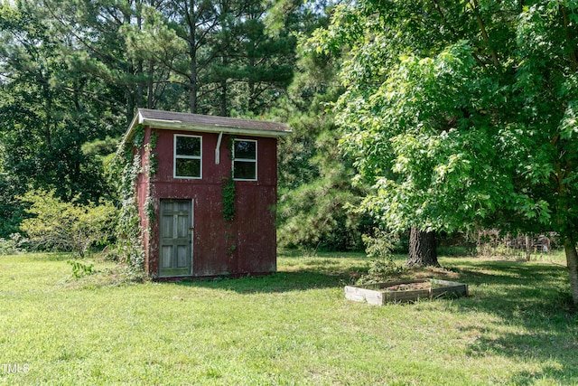 5840 Rocking Chair Dr, Youngsville, NC 27596 - view of shed with a vegetable garden