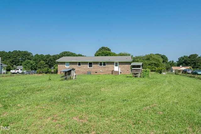 5840 Rocking Chair Dr, Youngsville, NC 27596 - back of house with a lawn, an outdoor structure, brick siding, and exterior structure
