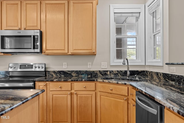 1806 White Dogwood Rd, Apex, NC 27502 - kitchen featuring appliances with stainless steel finishes, dark stone counters, and light brown cabinetry