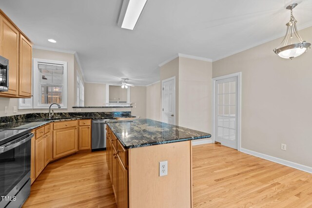 1806 White Dogwood Rd, Apex, NC 27502 - kitchen with appliances with stainless steel finishes, light wood finished floors, ornamental molding, dark stone countertops, and a center island