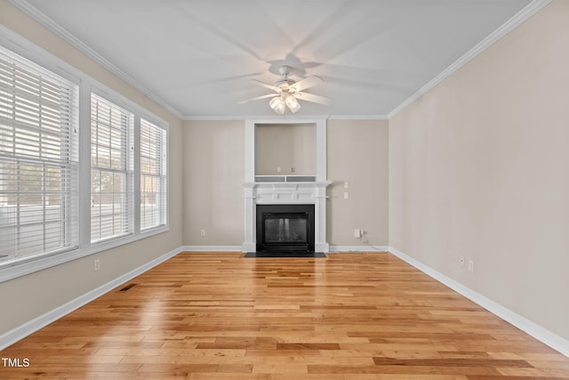 1806 White Dogwood Rd, Apex, NC 27502 - unfurnished living room with a ceiling fan, light wood-style floors, crown molding, and a fireplace with flush hearth