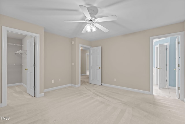 1806 White Dogwood Rd, Apex, NC 27502 - unfurnished bedroom featuring light colored carpet, a spacious closet, and ceiling fan