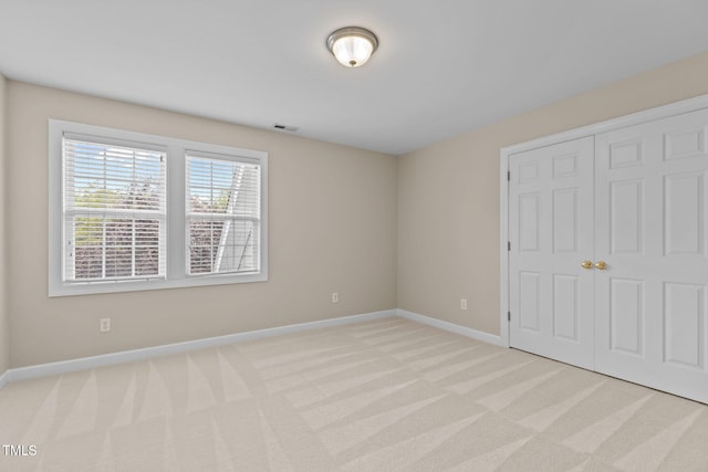 1806 White Dogwood Rd, Apex, NC 27502 - unfurnished bedroom featuring light colored carpet and a closet