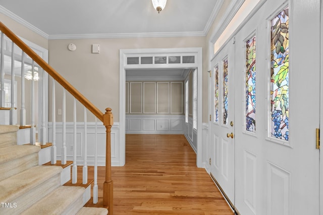 1806 White Dogwood Rd, Apex, NC 27502 - foyer entrance with stairs, light wood-style flooring, ornamental molding, and a decorative wall