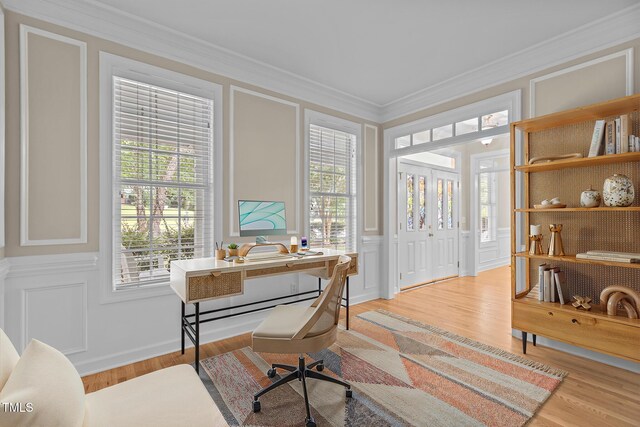 1806 White Dogwood Rd, Apex, NC 27502 - home office featuring a decorative wall, crown molding, healthy amount of natural light, light wood-style flooring, and a wainscoted wall