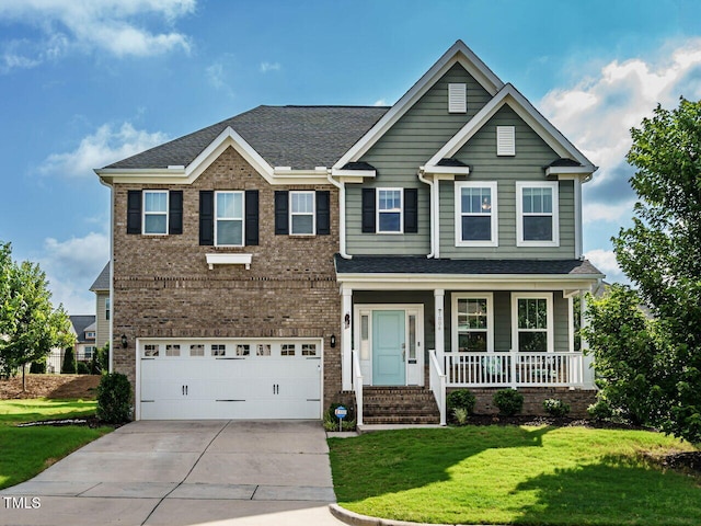 1004 Dogwood Bloom Ln, Knightdale, NC 27545 - view of front facade featuring covered porch, concrete driveway, a front lawn, and a garage