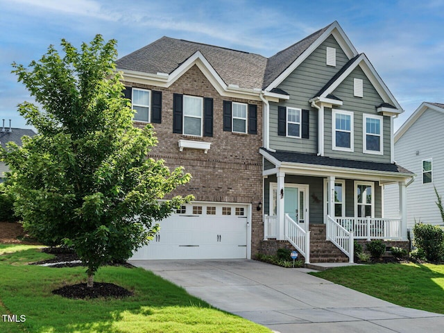1004 Dogwood Bloom Ln, Knightdale, NC 27545 - view of front of home with covered porch, driveway, a garage, a front yard, and brick siding