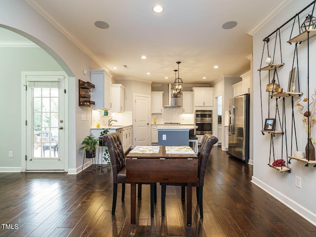 1004 Dogwood Bloom Ln, Knightdale, NC 27545 - dining area with dark wood-type flooring, arched walkways, recessed lighting, and ornamental molding