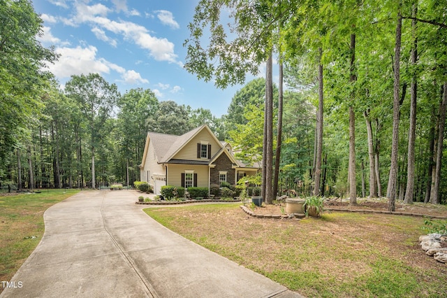 1513 Anterra Dr, Wake Forest, NC 27587 - view of front of house featuring concrete driveway, a front yard, and a wooded view