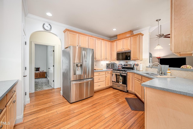 1513 Anterra Dr, Wake Forest, NC 27587 - kitchen featuring appliances with stainless steel finishes, light brown cabinets, crown molding, backsplash, and light wood-style floors