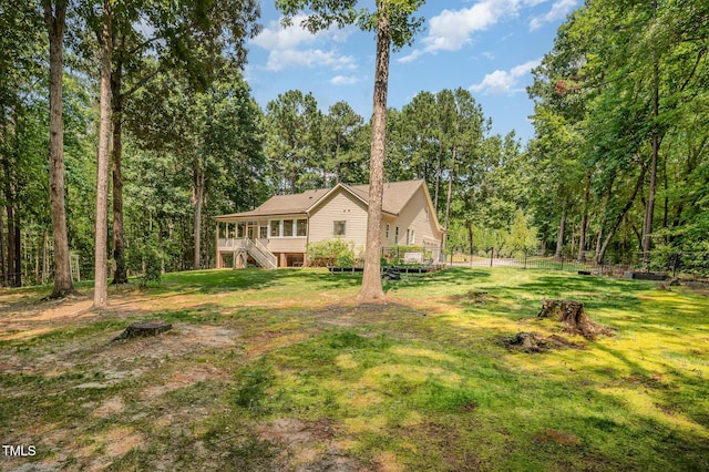 1513 Anterra Dr, Wake Forest, NC 27587 - view of front facade featuring stairway, a deck, a front lawn, and a wooded view