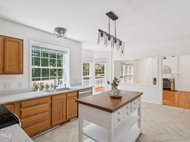 104 Pellinore Ct, Cary, NC 27513 - kitchen featuring brown cabinets, decorative light fixtures, dishwasher, and range