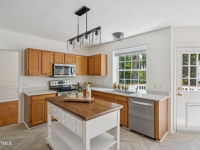 104 Pellinore Ct, Cary, NC 27513 - kitchen featuring stainless steel appliances, open shelves, plenty of natural light, and brown cabinets