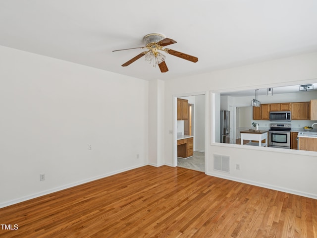 104 Pellinore Ct, Cary, NC 27513 - unfurnished living room with light wood-style flooring and a ceiling fan