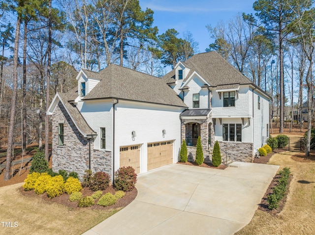 2105 Gardenbrook Dr, Raleigh, NC 27606 - view of front facade featuring stone siding, a shingled roof, and driveway