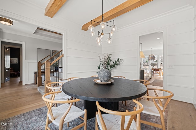 2105 Gardenbrook Dr, Raleigh, NC 27606 - dining room featuring a decorative wall, light wood finished floors, stairway, ornamental molding, and beam ceiling