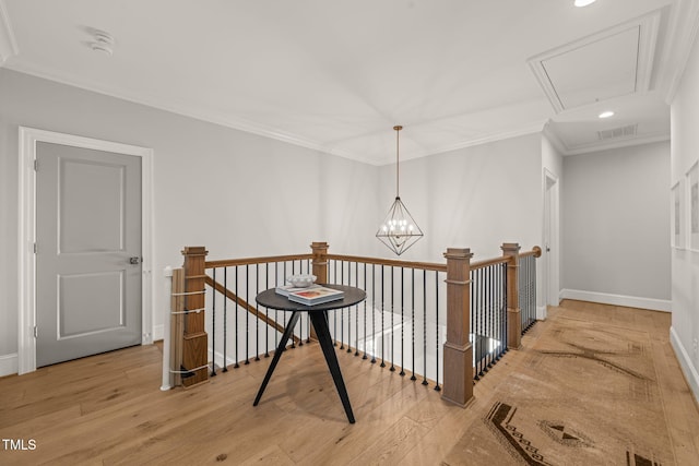 2105 Gardenbrook Dr, Raleigh, NC 27606 - corridor featuring an upstairs landing, attic access, light wood finished floors, ornamental molding, and recessed lighting