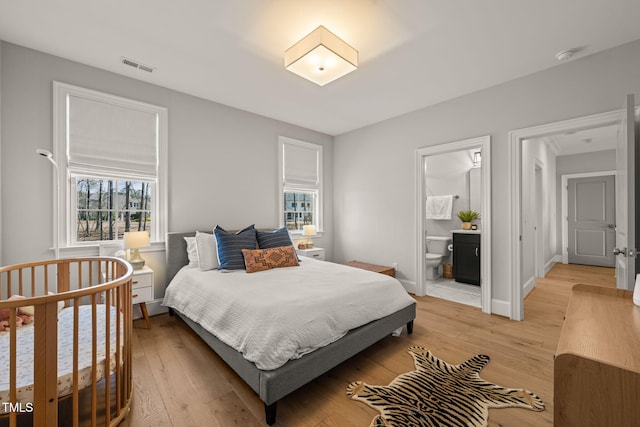 2105 Gardenbrook Dr, Raleigh, NC 27606 - bedroom with light wood-style flooring and connected bathroom