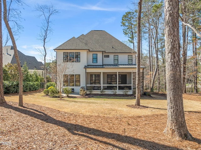 2105 Gardenbrook Dr, Raleigh, NC 27606 - rear view of house featuring a standing seam roof, a metal roof, roof with shingles, and a yard