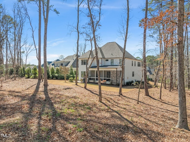 2105 Gardenbrook Dr, Raleigh, NC 27606 - back of property featuring a metal roof, a standing seam roof, and stone siding