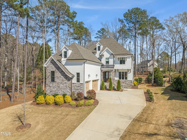 2105 Gardenbrook Dr, Raleigh, NC 27606 - view of front of house featuring stone siding, driveway, a garage, and roof with shingles