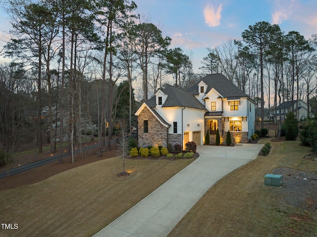 2105 Gardenbrook Dr, Raleigh, NC 27606 - view of front of property with driveway, stone siding, stucco siding, and a standing seam roof