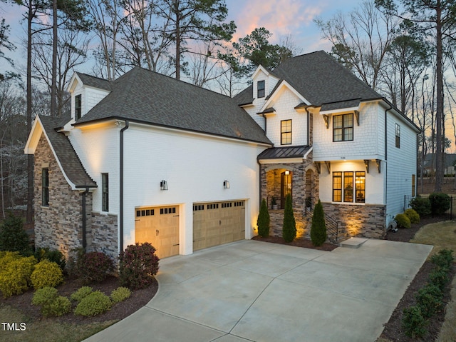 2105 Gardenbrook Dr, Raleigh, NC 27606 - view of front facade with concrete driveway, stone siding, a shingled roof, an attached garage, and a standing seam roof
