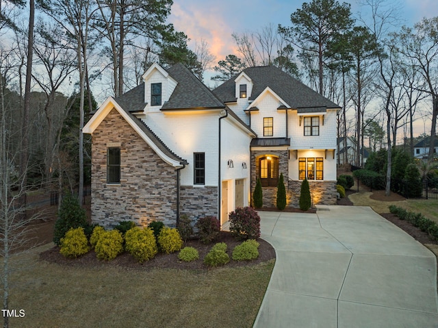 2105 Gardenbrook Dr, Raleigh, NC 27606 - view of front of property featuring stone siding, driveway, a standing seam roof, and a metal roof
