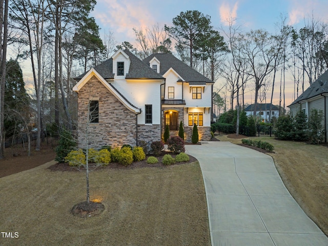 2105 Gardenbrook Dr, Raleigh, NC 27606 - view of front of house featuring stone siding, concrete driveway, and a front yard