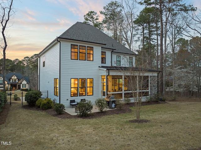 2105 Gardenbrook Dr, Raleigh, NC 27606 - back of house with a patio, roof with shingles, and a sunroom
