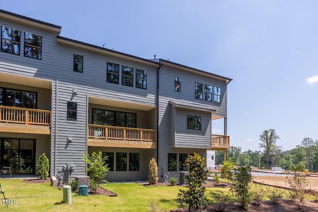 4703 Mint Leaf Ln, Raleigh, NC 27612 - rear view of house featuring a yard and a balcony