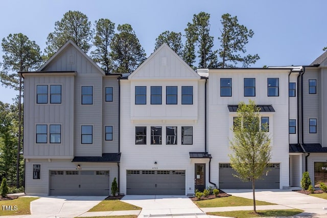 4703 Mint Leaf Ln, Raleigh, NC 27612 - view of property with board and batten siding, a garage, and driveway