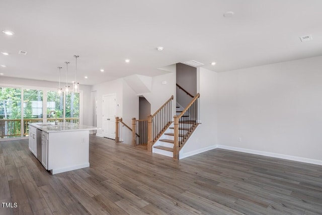 4703 Mint Leaf Ln, Raleigh, NC 27612 - kitchen with a kitchen island with sink, dark wood-style floors, light countertops, recessed lighting, and stainless steel dishwasher