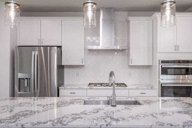 4703 Mint Leaf Ln, Raleigh, NC 27612 - kitchen featuring stainless steel appliances, wall chimney range hood, tasteful backsplash, and white cabinetry
