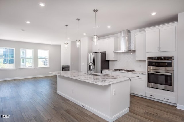 4703 Mint Leaf Ln, Raleigh, NC 27612 - kitchen featuring wall chimney range hood, stainless steel appliances, white cabinetry, dark wood-type flooring, and tasteful backsplash