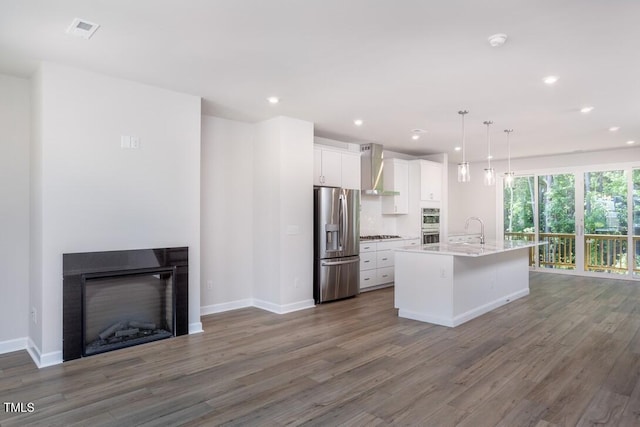 4703 Mint Leaf Ln, Raleigh, NC 27612 - kitchen featuring stainless steel appliances, dark wood-style floors, white cabinets, open floor plan, and a center island with sink