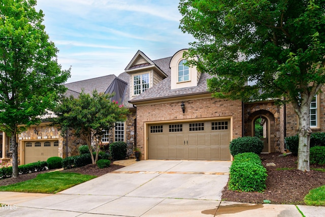 4164 English Garden Way, Raleigh, NC 27612 - view of front of property with driveway, a garage, roof with shingles, and brick siding