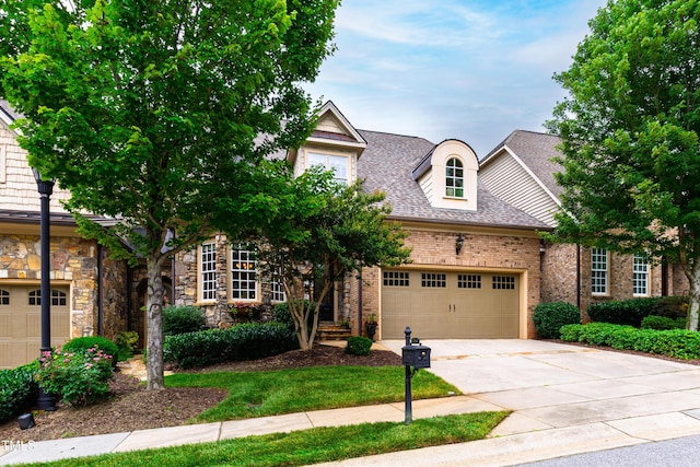 4164 English Garden Way, Raleigh, NC 27612 - view of front of house featuring concrete driveway, a garage, a shingled roof, and brick siding