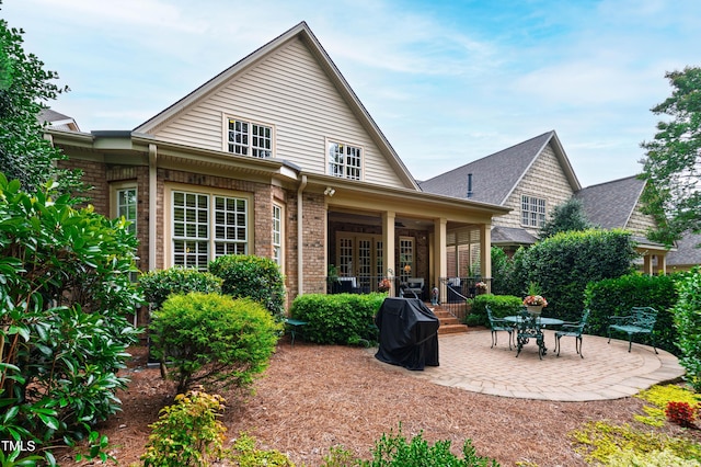4164 English Garden Way, Raleigh, NC 27612 - back of property featuring a patio area and brick siding