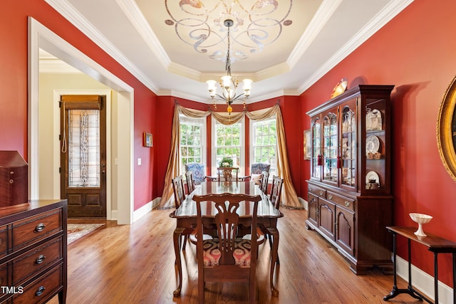 4164 English Garden Way, Raleigh, NC 27612 - dining area with a chandelier, light wood-type flooring, a tray ceiling, and ornamental molding