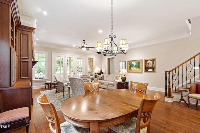 4164 English Garden Way, Raleigh, NC 27612 - dining room with ornamental molding, a chandelier, recessed lighting, wood finished floors, and stairs