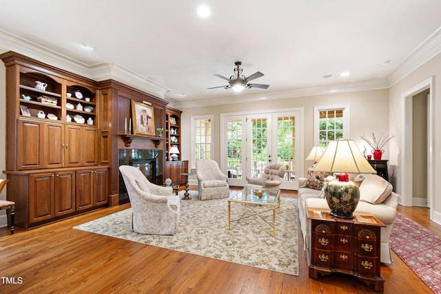 4164 English Garden Way, Raleigh, NC 27612 - living room featuring a premium fireplace, ceiling fan, ornamental molding, light wood-style floors, and recessed lighting