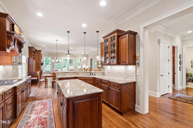 4164 English Garden Way, Raleigh, NC 27612 - kitchen with a peninsula, glass insert cabinets, hanging light fixtures, decorative backsplash, and recessed lighting